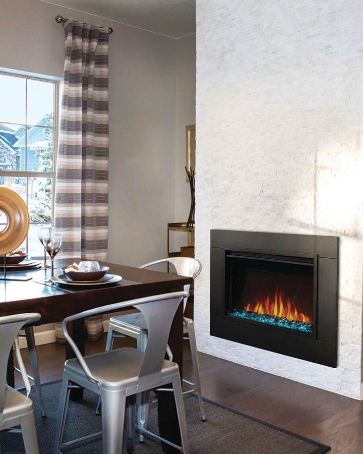 an electric fireplace set into the wall of the dining room in a bright modern home