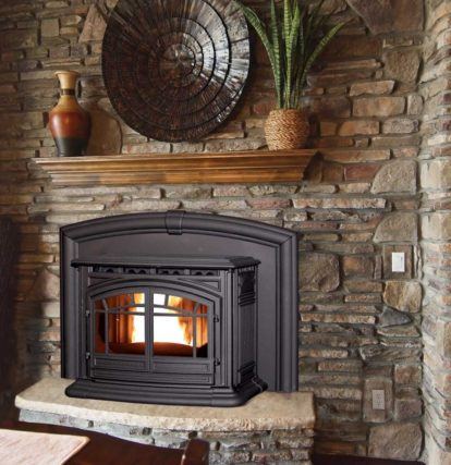 a traditional iron fireplace set into a stone hearth in a rustic home